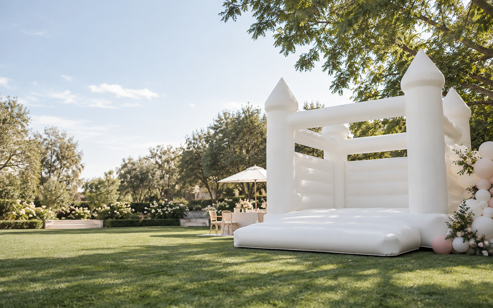 White inflatable bounce house set up for a backyard celebration